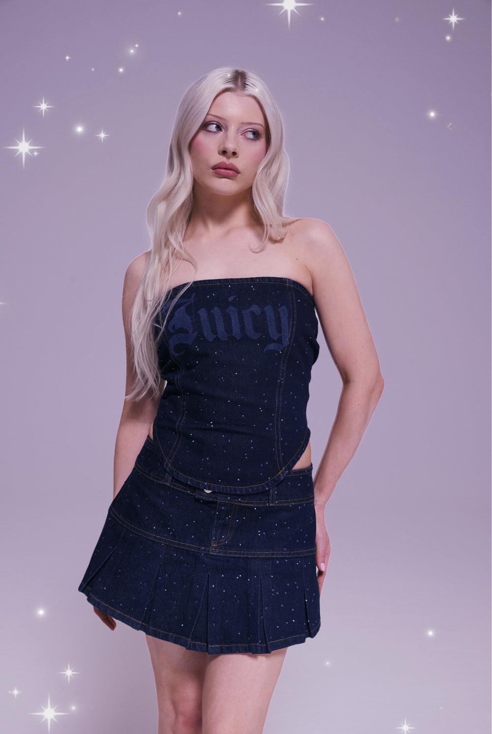 Displays a model wearing the Disney 'Juicy' branded denim diamanté scatter pleated skirt