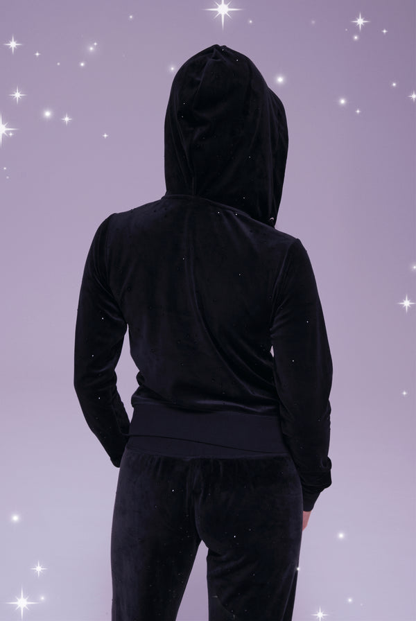 Displays a model wearing the Disney black 'juicy' branded Diamanté hoodie 