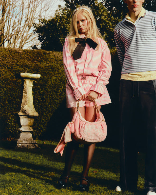 Displays a model wearing the White Striped 'Juicy' branded boxer short pyjama included in the pyjama set
