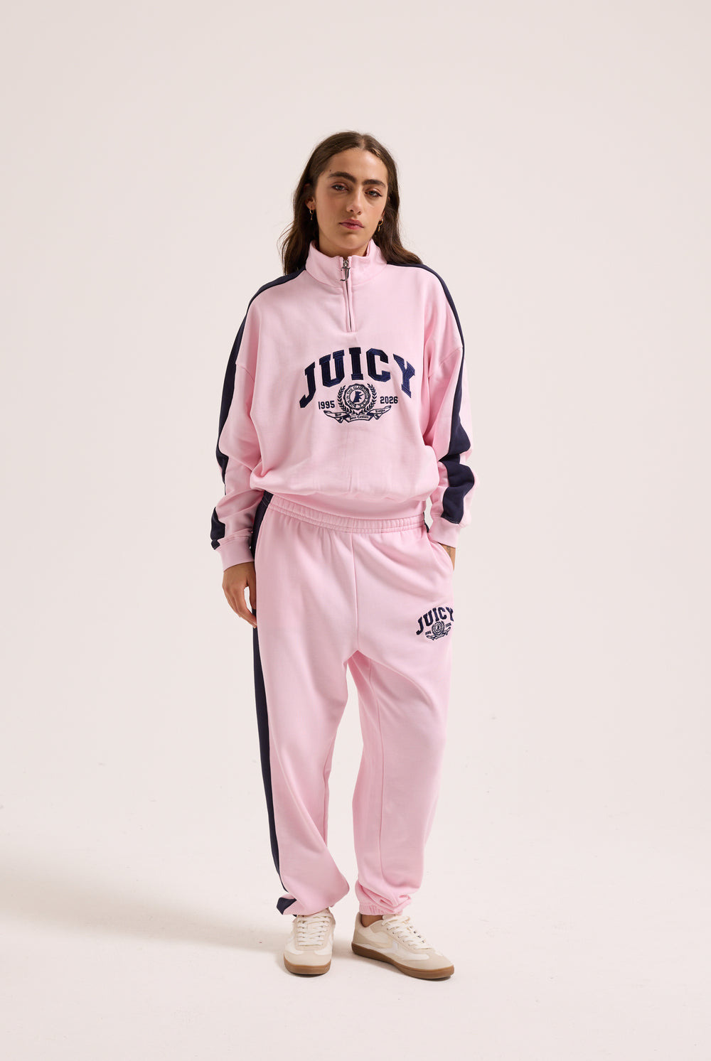 Displays a model wearing the Cherry Blossom 'Juicy' branded college crest track top  