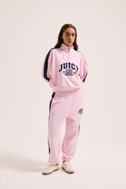 Displays a model wearing the Cherry Blossom 'Juicy' branded college crest track top  