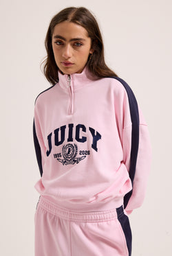 Displays a model wearing the Cherry Blossom 'Juicy' branded college crest track top  