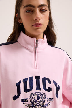 Displays a model wearing the Cherry Blossom 'Juicy' branded college crest track top  