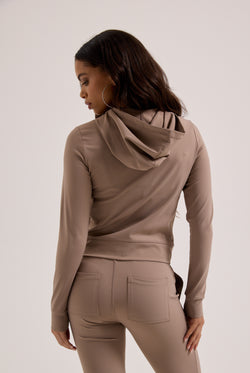 Displays a model wearing the Fungi peached 'Juicy' branded active fitted hoodie