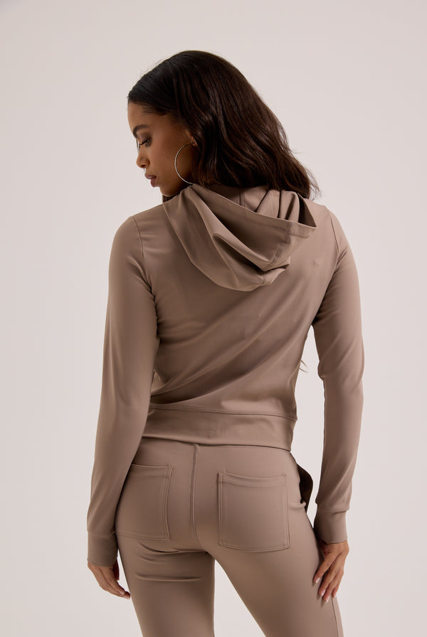 Displays a model wearing the Fungi peached 'Juicy' branded active low rise pants 