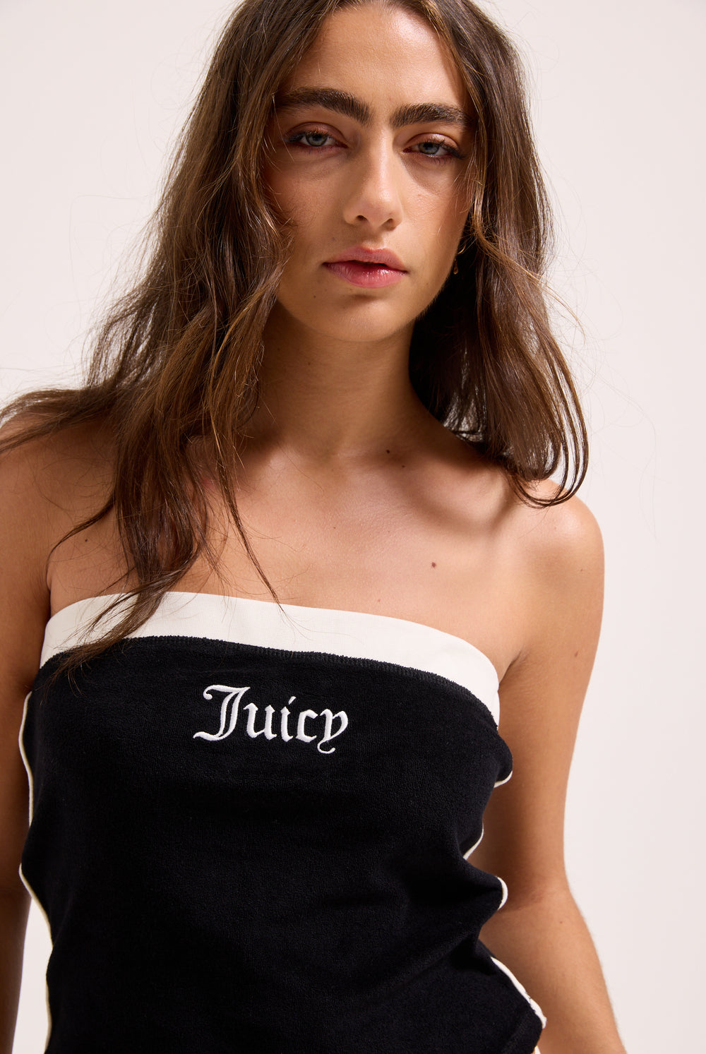 Displays a model wearing the Black contrast 'Juicy' branding Terry bandeau 