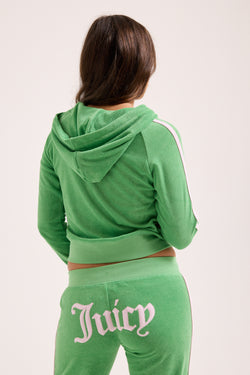 Displays a model wearing the Peppermint appliqué 'juicy' branded Terry shrunken hoodie 