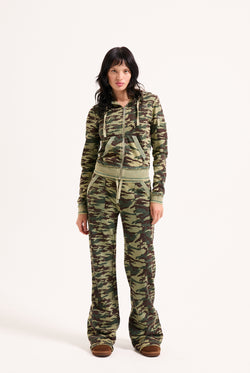 Displays a model wearing the Camo Print 'Juicy' branded washed cotton hoodie 