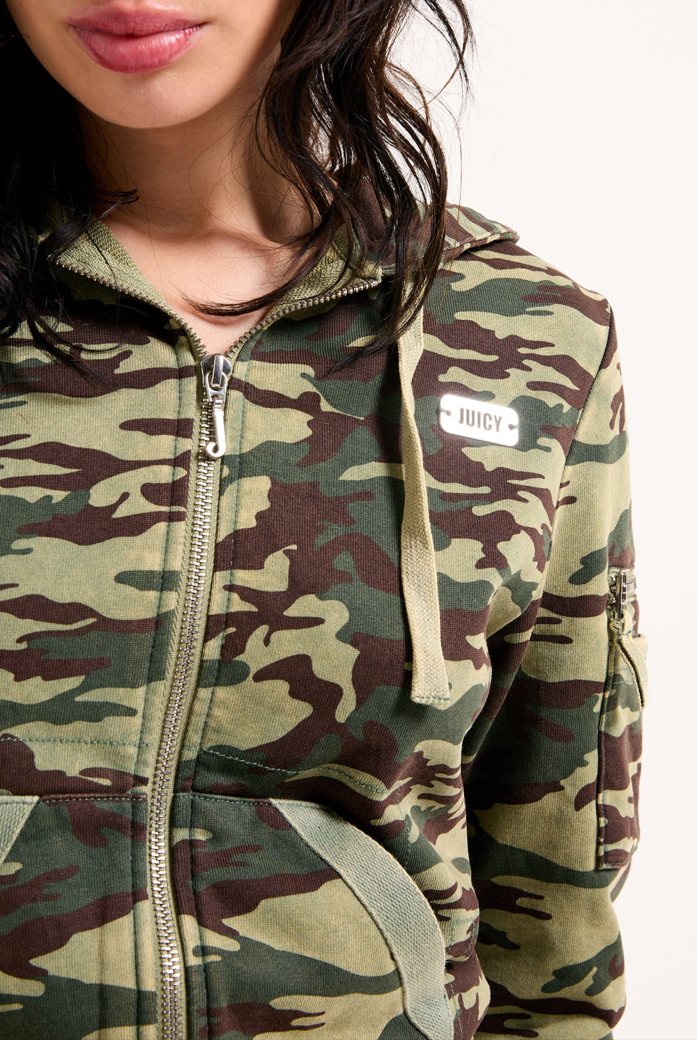 Displays a model wearing the Camo Print 'Juicy' branded washed cotton hoodie 