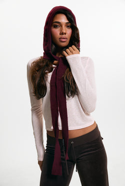 Displays a model wearing the Burgundy 'Juicy' branded Bonnet With Bow