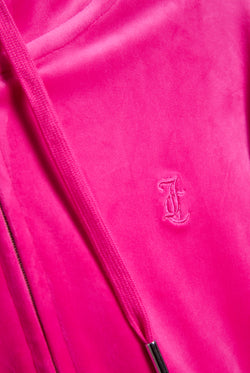 Displays he Nostalgia Pink 'Juicy' branded pink crop oversized classic velour hoodie featuring the juicy couture branding 