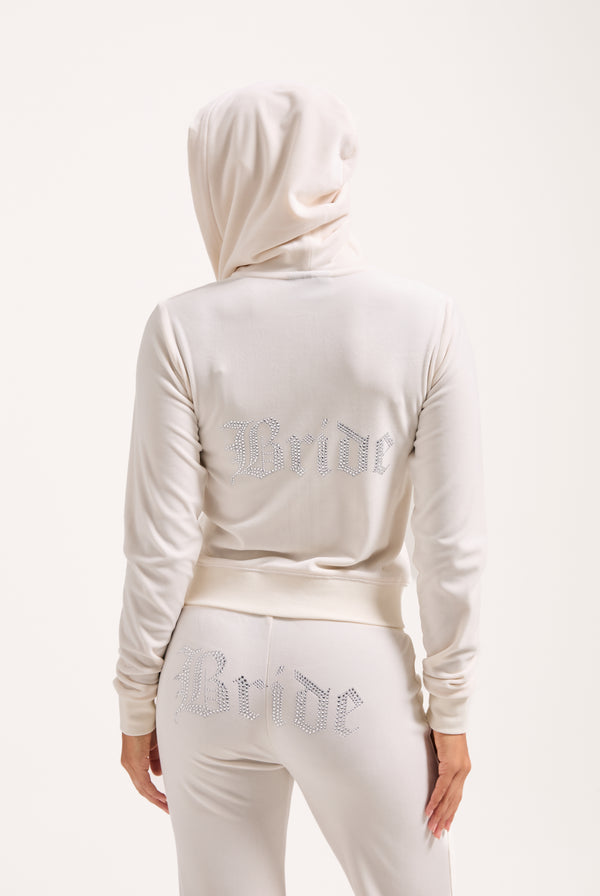 Displays a model wearing the Bridal 'Juicy' branded classic velour hoodie 