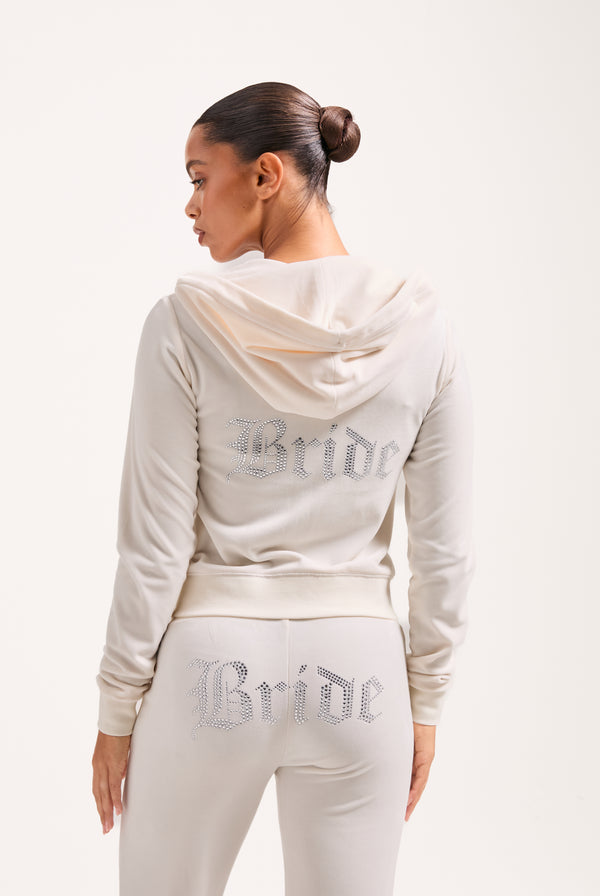 Displays a model wearing the Bridal 'Juicy' branded classic velour hoodie 