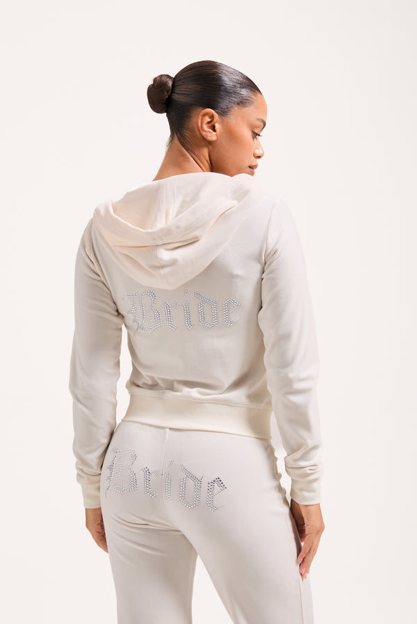 Displays a model wearing the Bridal 'Juicy' branded classic velour hoodie 