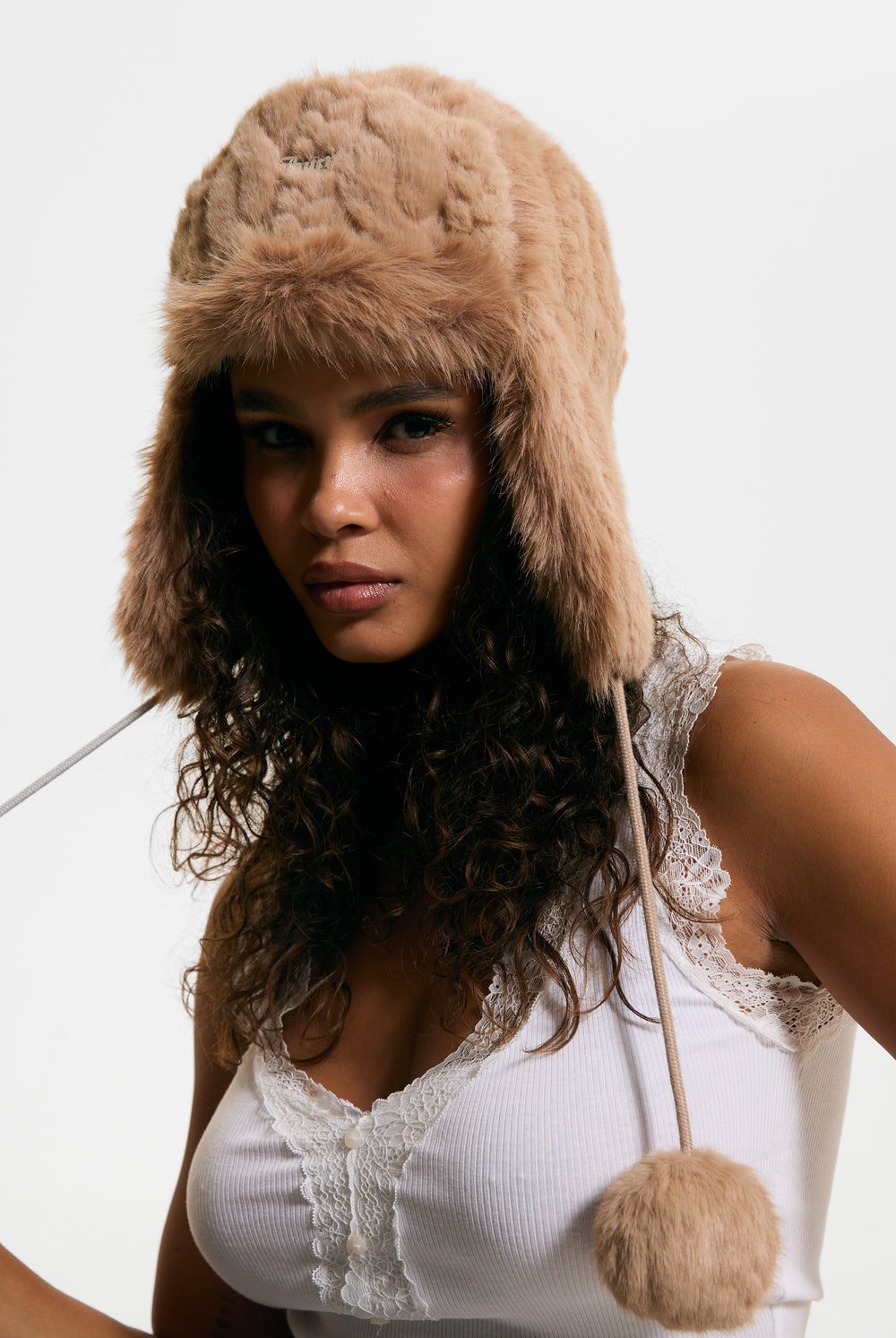 Displays a model wearing the Warm Taupe 'Juicy' branded Cable Knit Trapper With Fur Lining