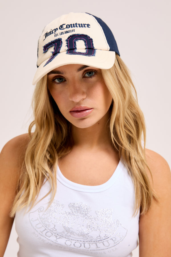 Display a model wearing the Ecru/Night sky cap