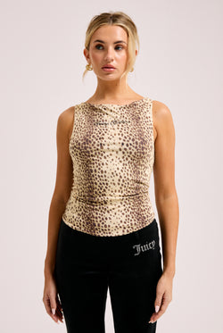 Displays a model wearing the natural cheetah print 'Juicy' off the shoulder top 