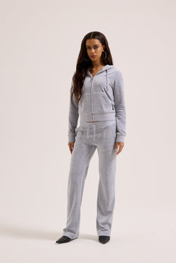 Woman wearing a gray tracksuit on a white background