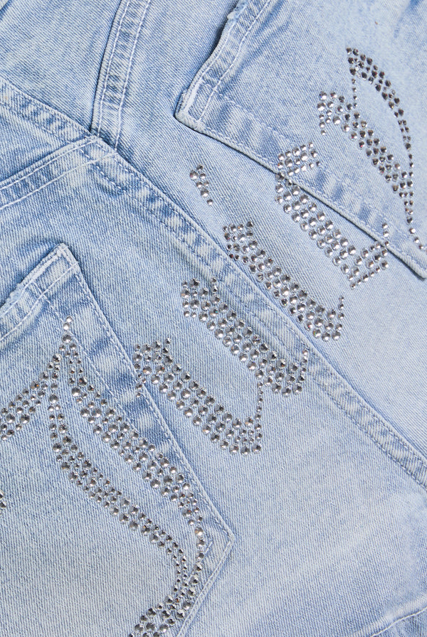 Displays the Light Wash 'Juicy' low rise denim booty short 