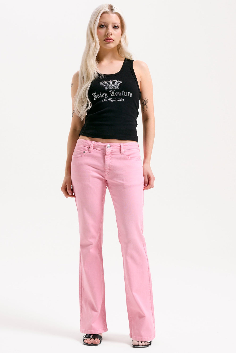 Displays a model wearing the Pink Wash 'Juicy' branded Digi Diamanté mid rise flared jeans