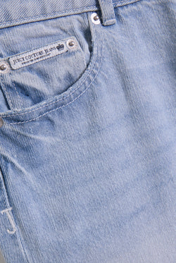 Displays the Light Wash 'Juicy' branded Dog crest bootcut jeans