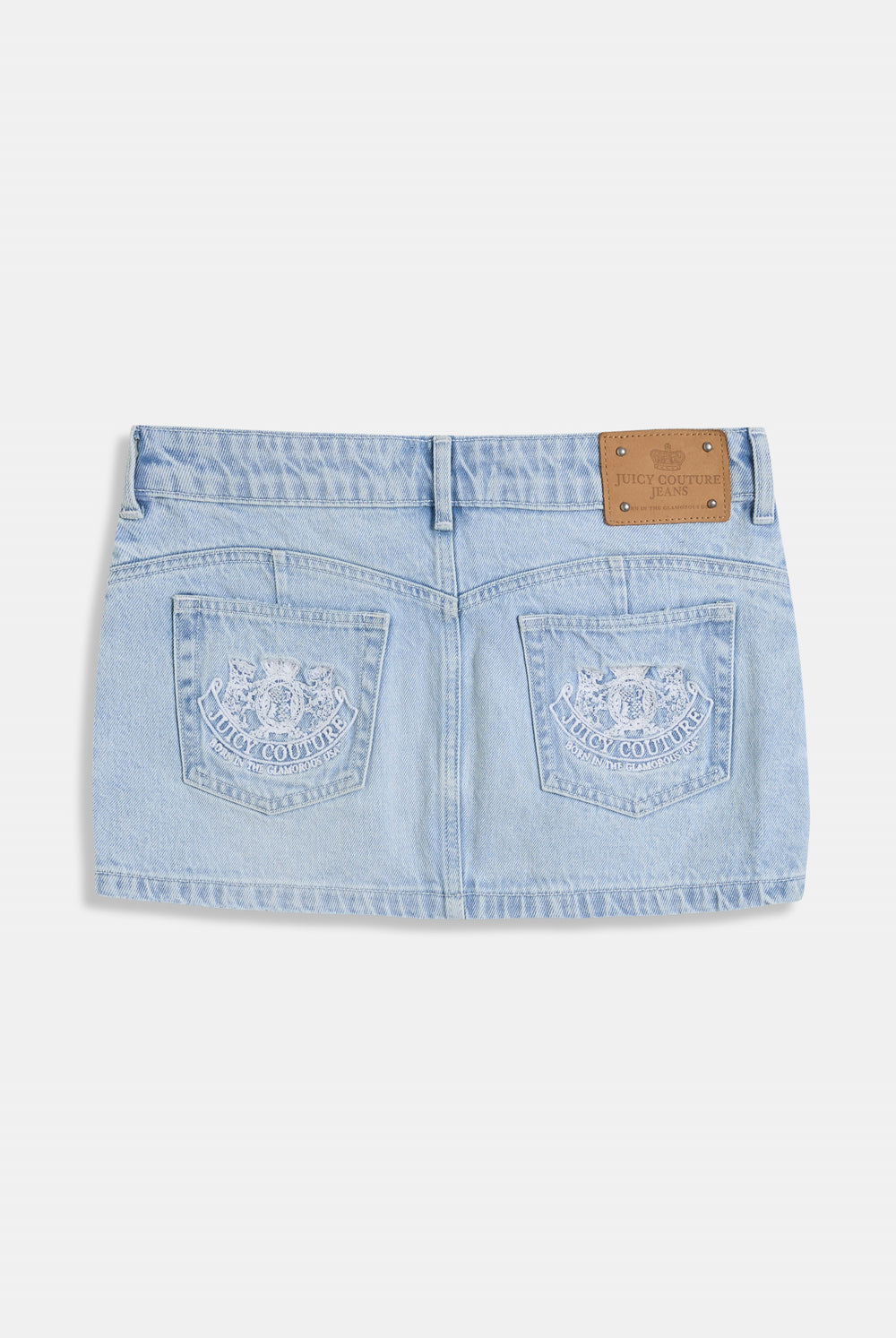 Displays the Light Wash 'Juicy' branded denim dog crest mini skirt 