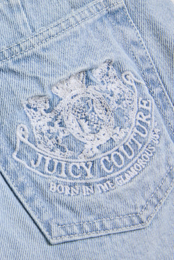 Displays the Light Wash 'Juicy' branded denim dog crest mini skirt featuring the juicy Couture branding 