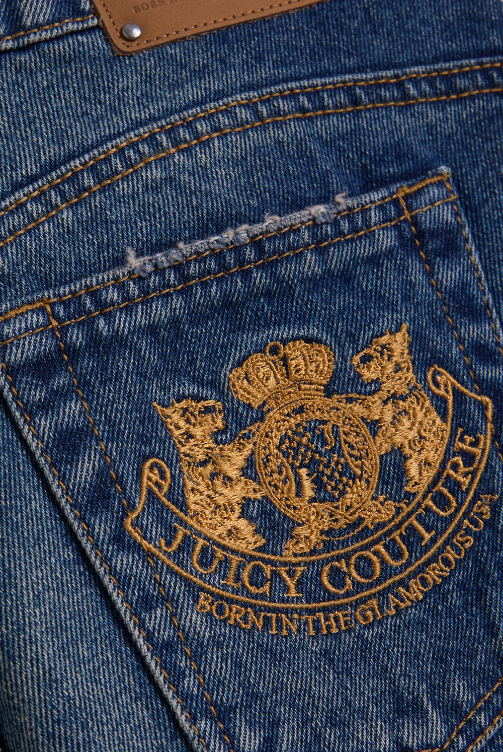 Displays the vintage wash mid rise wide leg 'Juicy' branded jeans featuring the juicy Couture logo