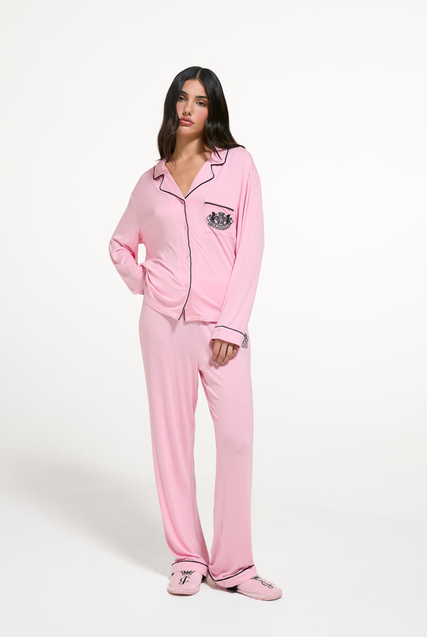 Displays a model wearing the Juicy Pink 'Juicy' branded Dog crest pyjama set 