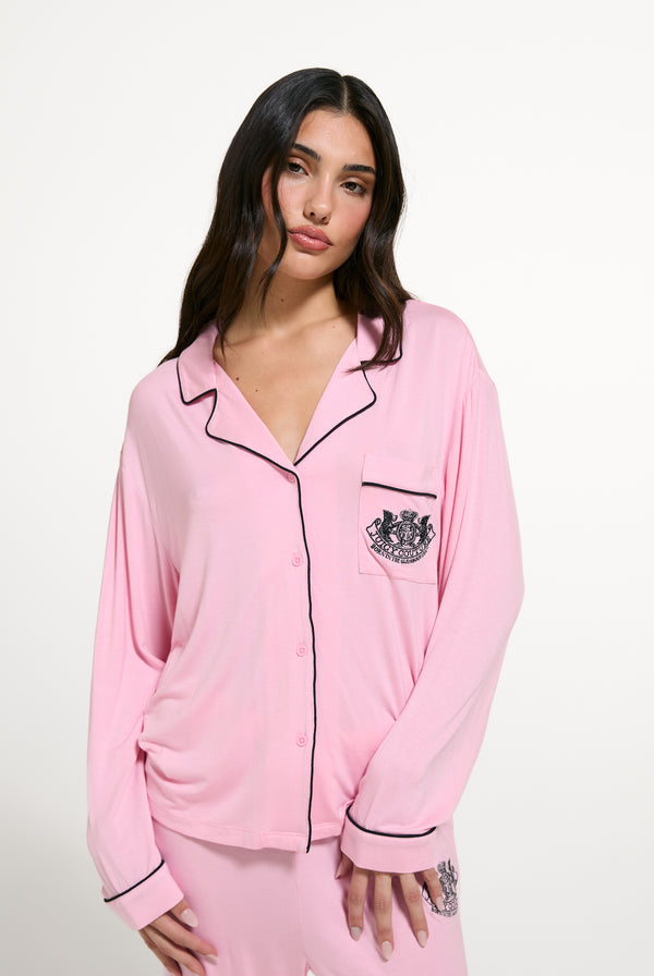 Displays a model wearing the Juicy Pink 'Juicy' branded Dog crest pyjama set 