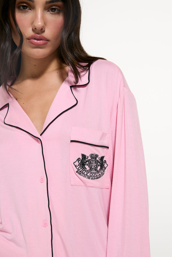 Displays a model wearing the Juicy Pink 'Juicy' branded Dog crest pyjama set 