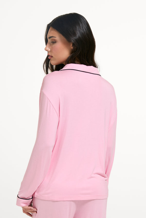 Displays a model wearing the Juicy Pink 'Juicy' branded Dog crest pyjama set 