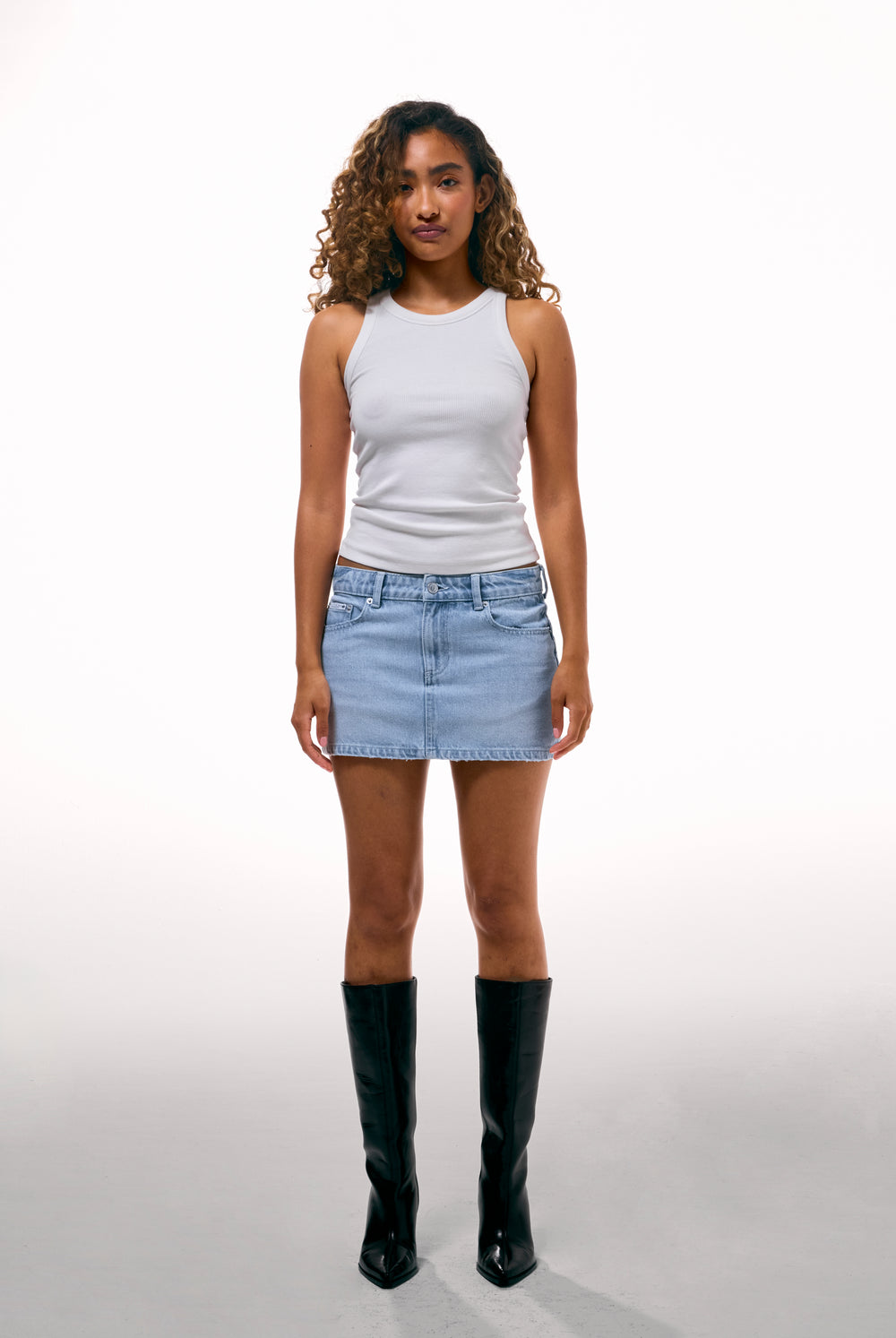 Displays a model wearing the Light Wash 'Juicy' branded denim dog crest mini skirt 