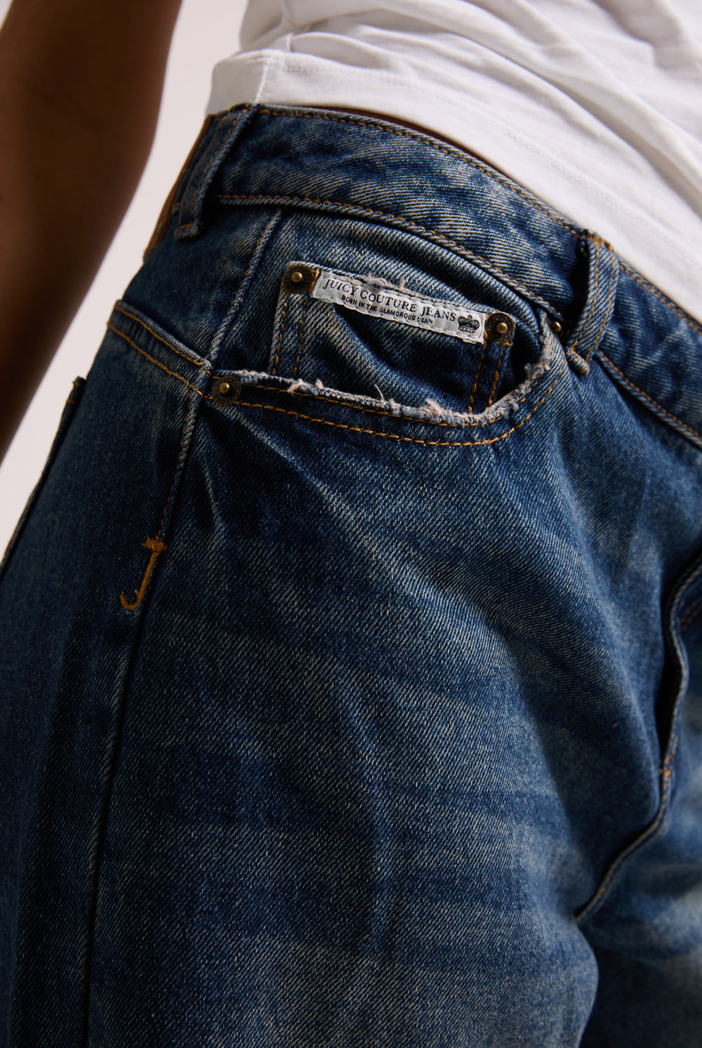 Displays a model wearing the vintage wash mid rise wide leg 'Juicy' branded jeans 