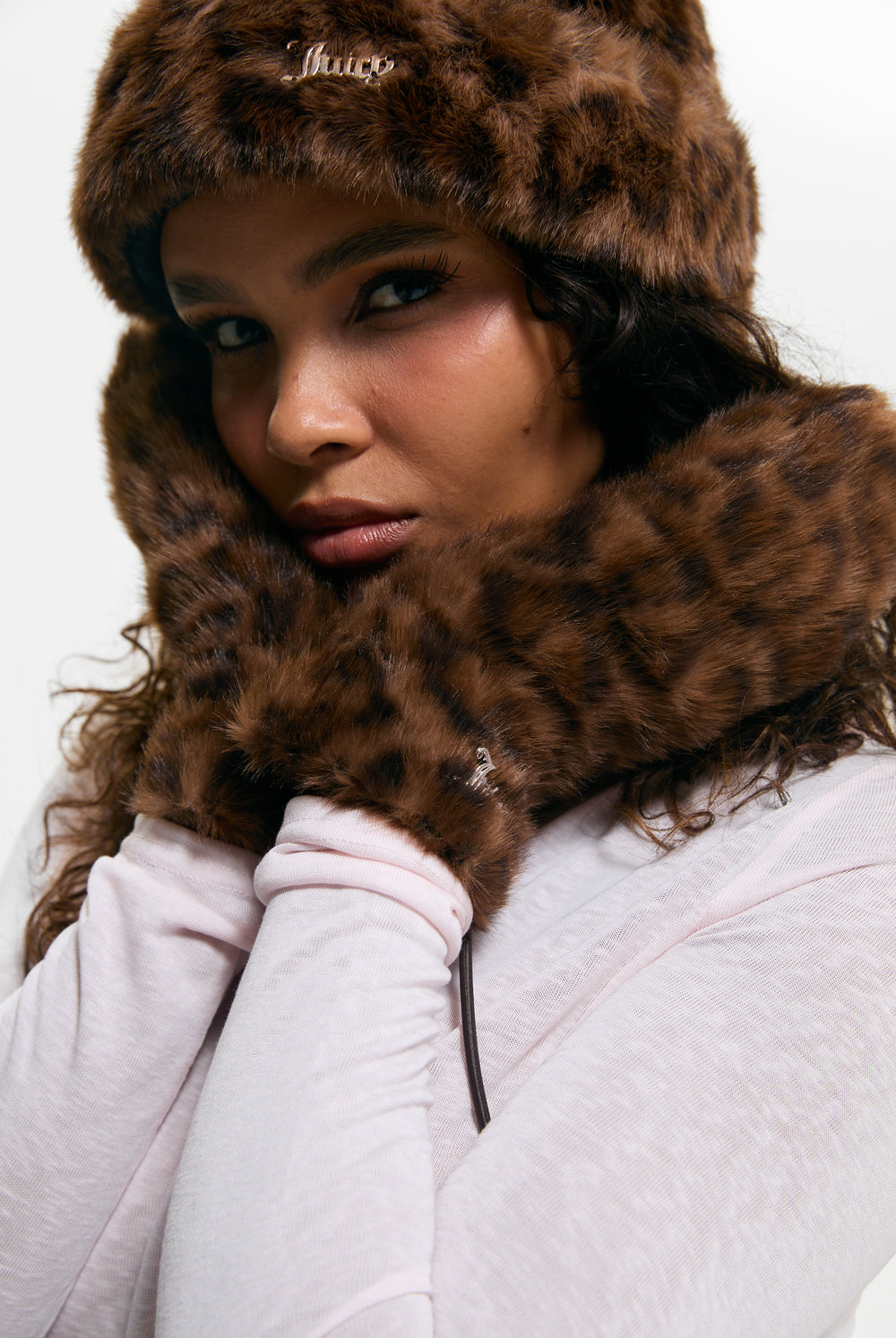 Displays a model wearing the Leopard Print 'Juicy' branded Drawstring Fur Mittens