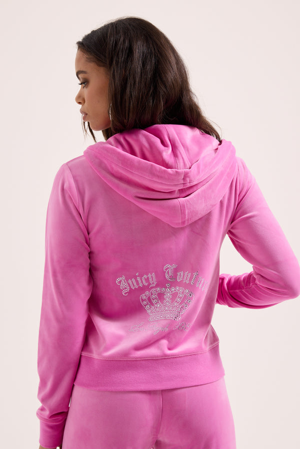 Displays a model wearing the super pink 'juicy' branded gothic crown classic velour hoodie 