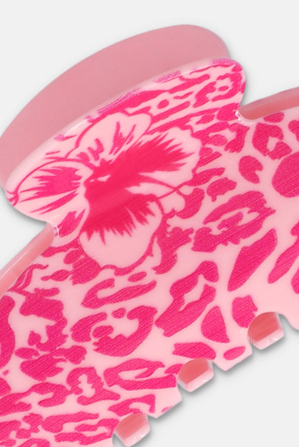 Displays a juicy pink 'juicy' branded 2 pack claw clip