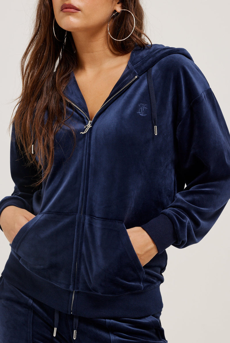 Displays a model wearing the Night Sky 'Juicy' branded classic velour oversized hoodie 