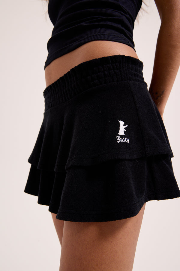 Displays a model wearing the Black Heritage 'Juicy' branded smoked tier skirt