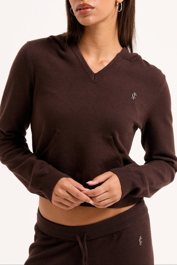 Displays a model wearing the Java 'juicy' branded heritage knit hoodie 