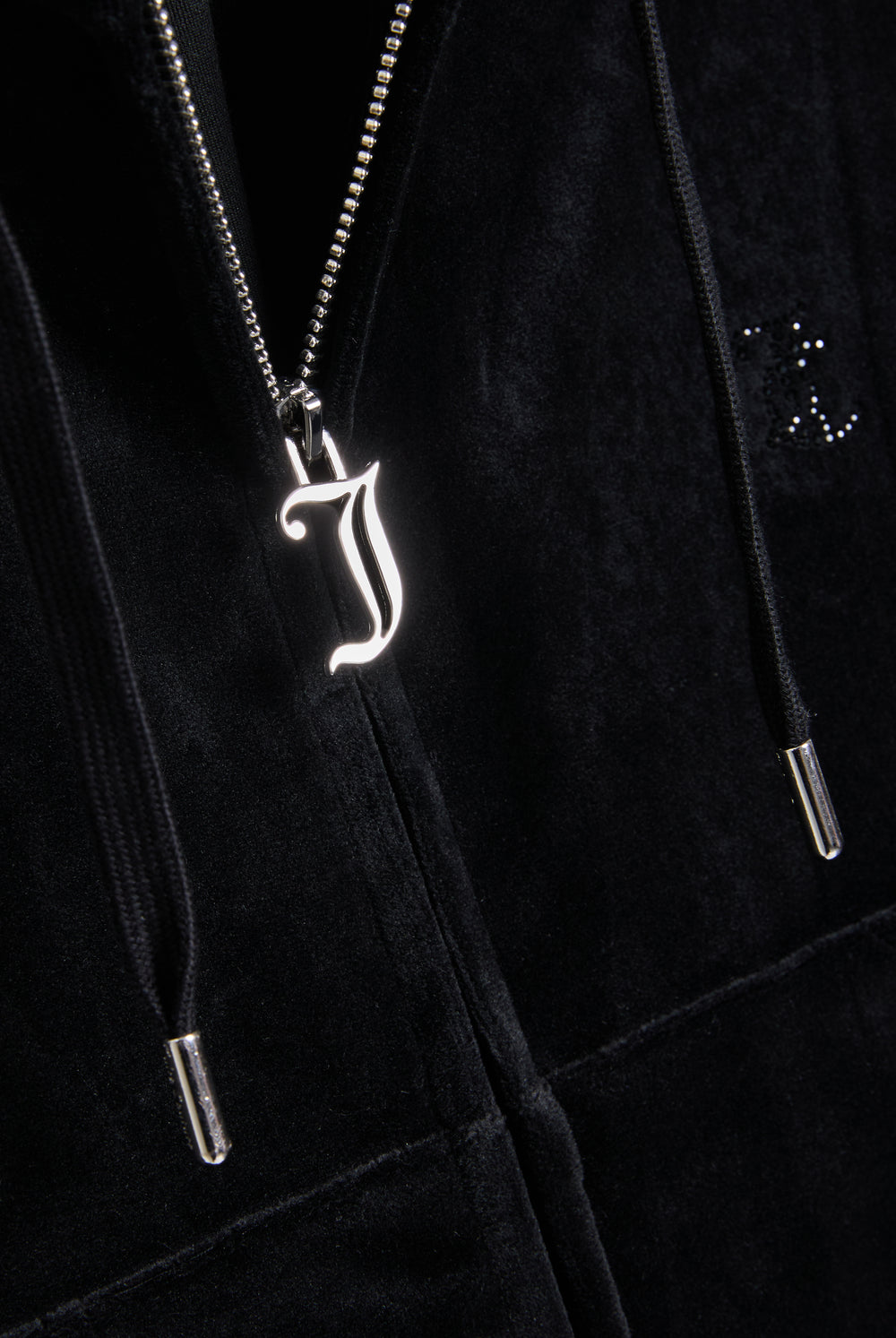 Displays the Black 'Juicy' branded outline diamanté oversized cropped hoodie featuring the juicy zip