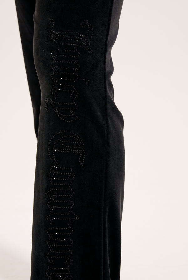 Displays the Black outline 'Juicy' branded diamanté classic velour low rise pant featuring the juicy branding 