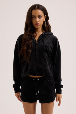 Displays a model wearing the Black outline 'Juicy' branded diamanté oversized cropped hoodie 