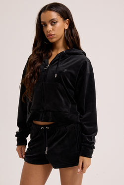 Displays a model wearing the Black outline 'Juicy' branded diamanté oversized cropped hoodie 