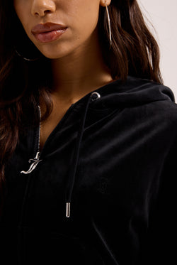 Displays a model wearing the Black outline 'Juicy' branded diamanté oversized cropped hoodie 