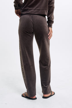 Displays a model wearing the Java 'Juicy' branded Old Gothic Diamante Og Straight Leg Trackpant