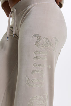 Displays a model wearing the String 'Juicy' branded Old Gothic Diamante Og Straight Leg Trackpant featuring close up on the details 
