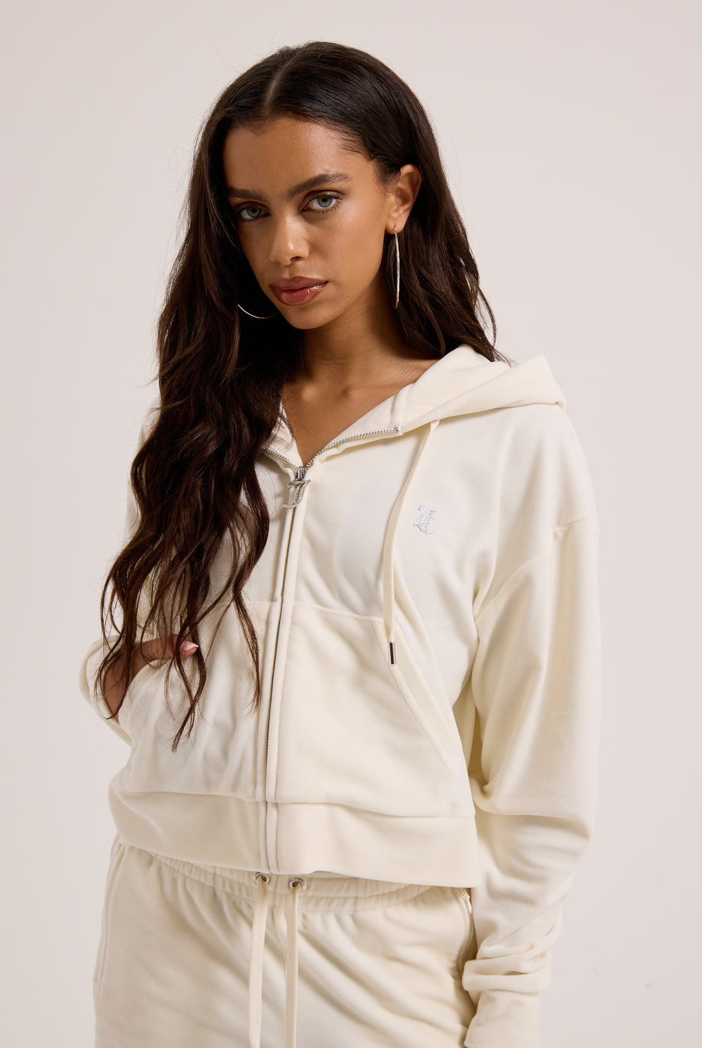 Displays a model wearing the Cream Outline 'Juicy' branded diamanté oversized cropped hoodie