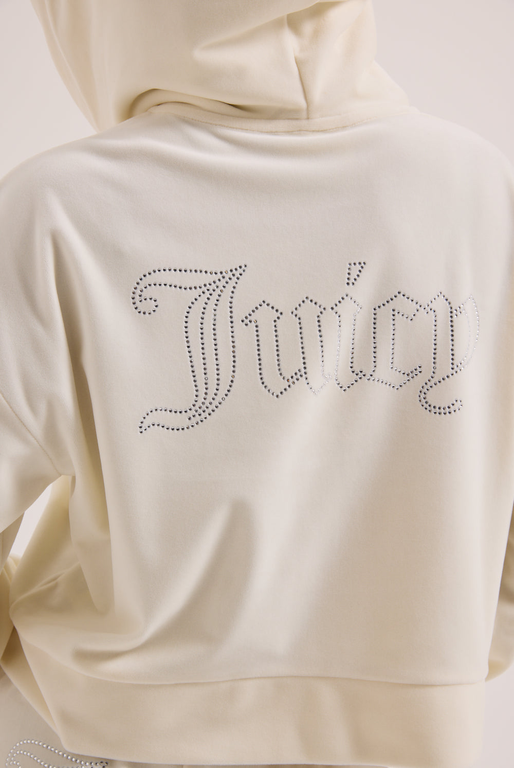 Displays the Cream Outline 'Juicy' branded diamanté oversized cropped hoodie featuring the juicy branding 