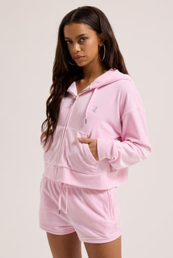 Displays a model wearing the Cherry Blossom 'juicy' branded outline diamanté oversized cropped velour hoodie 